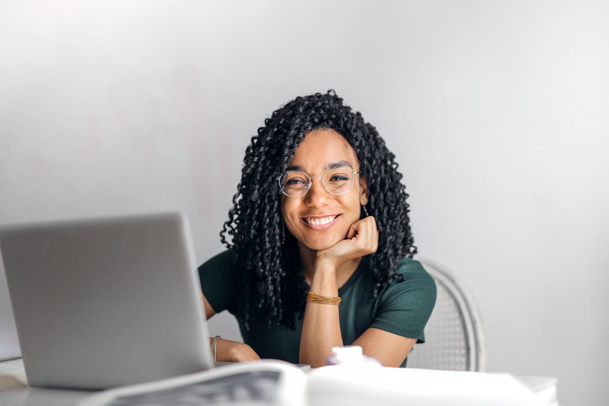 Woman at home completing questionnaire on laptop — face visible