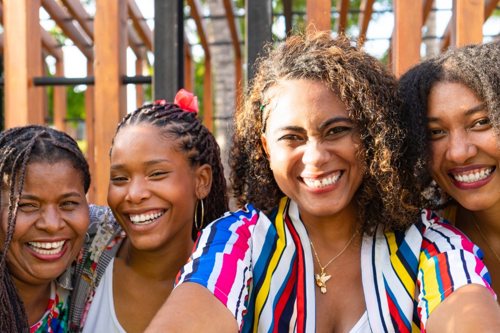 Diverse team of smiling women — community, warmth, and approachability